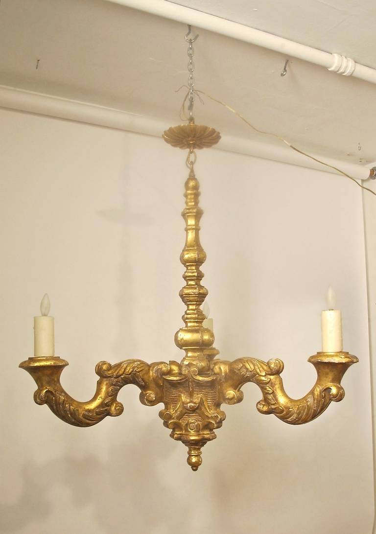 Carved and giltwood three-arm light fixture with custom carved and gilded canopy. Newly re-wired.