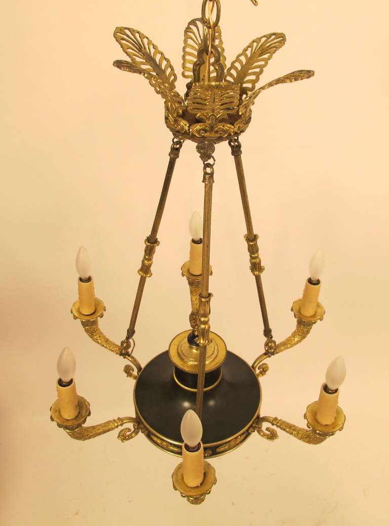This is a early to mid 20th century ceiling fixture, probably French, which has recently been rewired and cleaned. The fixture is gilt bronze with a painted metal base in a dark green color. There are 6 lights around a base that is 20" in