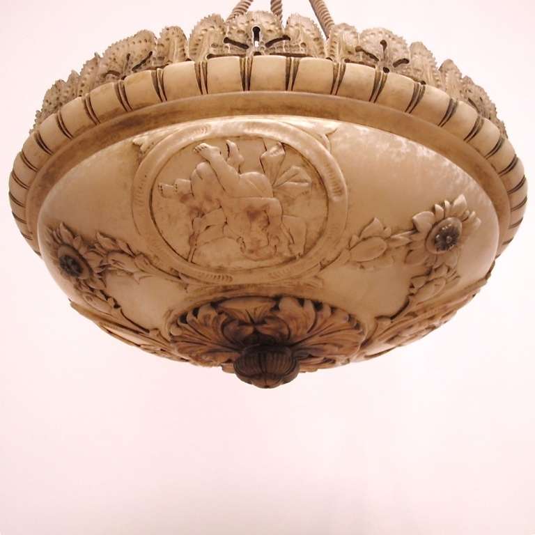 Elaborately carved alabaster bowl with alabaster canopy and braided rope hanger. Newly re-wired, holds three light bulbs. European, early 20th century.
