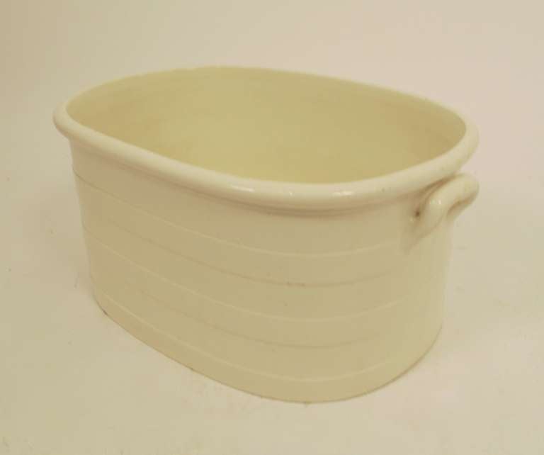The white foot bath is of a soft-paste porcelain in a classic linear design. The generous size allows for multiple uses, Center Piece with Flowers or Plants, Cooler for chilled wines and beverages. 
French, Circa 1860.