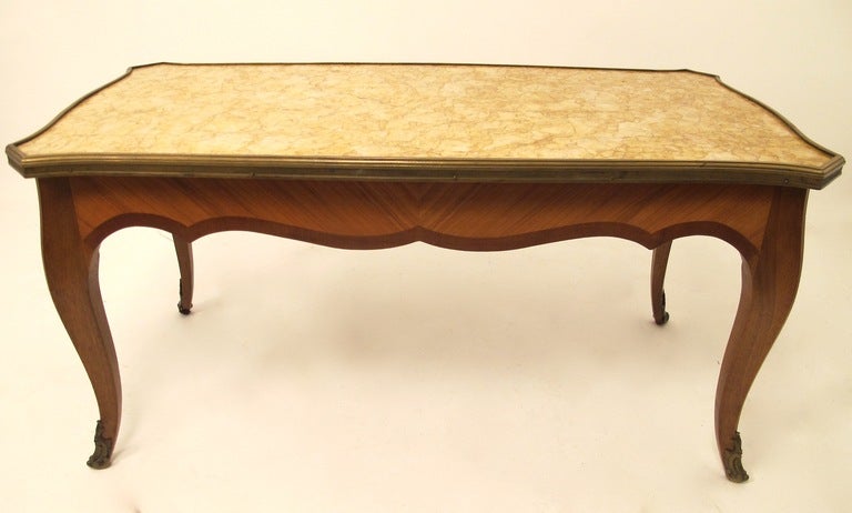 Shapely low table with marble top, bronze gallery and hardware. France, early 20th century circa 1920's.