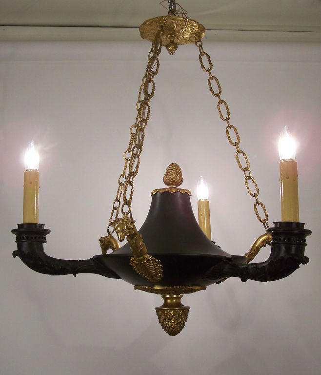 Patinated bronze three-light chandelier with gilt bronze accents. Recently rewired, chain length can be adjusted to accommodate specific length. French, empire style, circa 1880.
  
