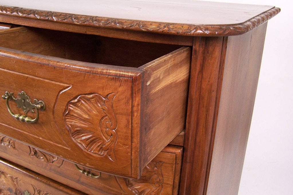 Beautifully carved solid walnut four drawer commode or chest of drawers. French or possibly Swiss, mid to late 18th century. 