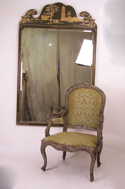 A large Georgian style Chinoiserie mirror, painted green with gilt decorated asian scene and aged beveled glass mirror. Continental, last quarter of the 20th century.
