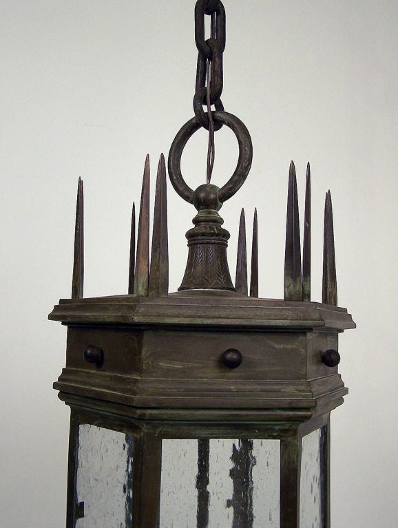 Baroque style bronze exterior hanging lantern with textured glass panels and with beautiful detailed castings and original patina. Excellent quality. Measurements do not include the chain. Early 20th century. Recently rewired.