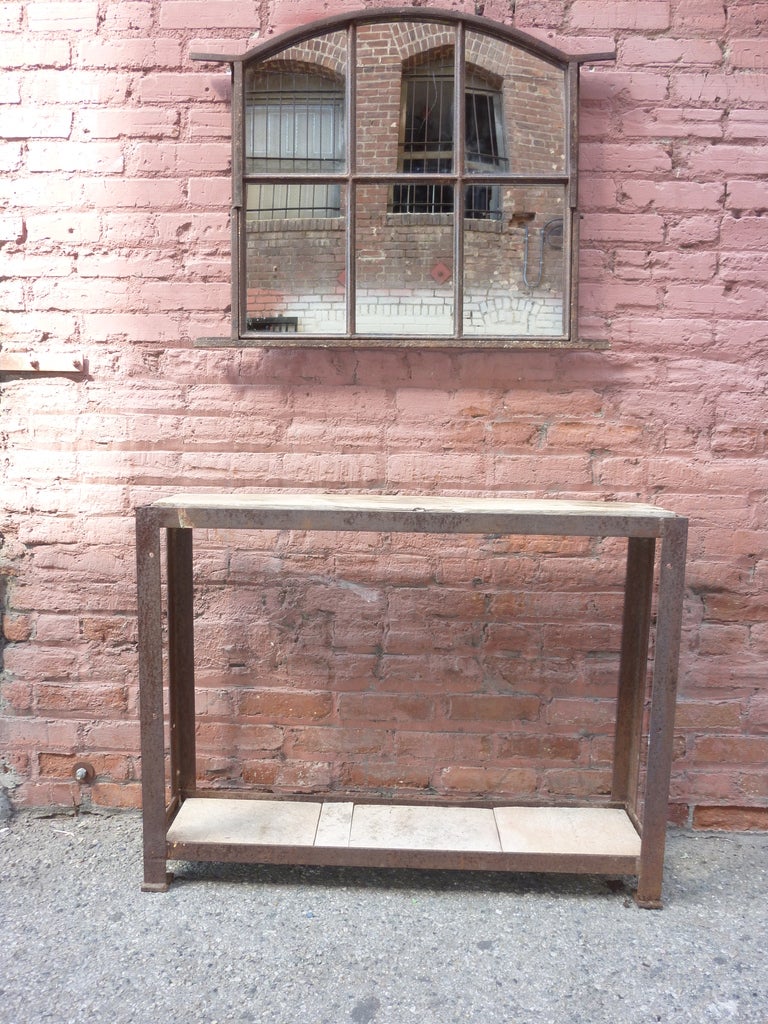 Iron hand made early 20th century mirror frame, and console from the same period tabletop is wood and bottom is stone. Mirror dimensions H 27.5 x L 34.5.