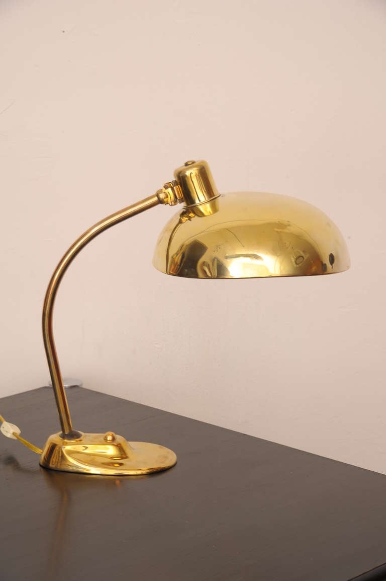Brass desk lamp  from the  metal workshop at the Bauhaus factory .
 adjustable shade and neck