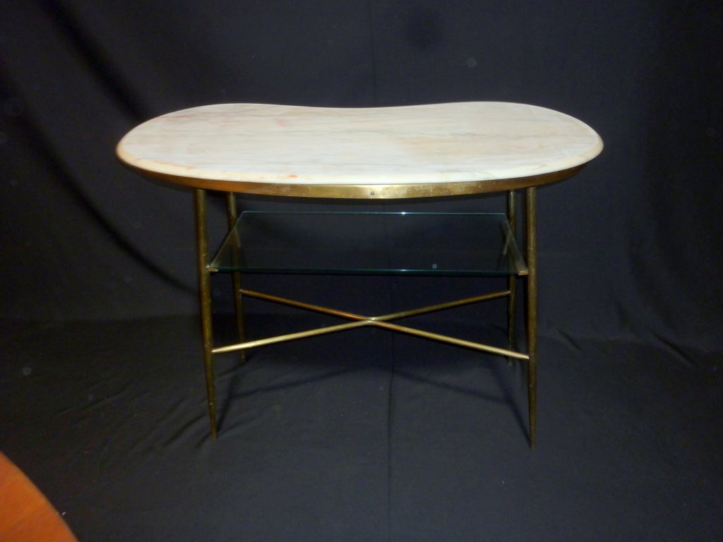 Kidney shape brass table. Top is Portogruaro rose stone and the glass shelf.