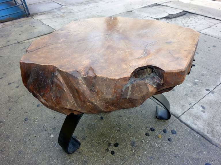 side table ,  heavy  metal legs are designed to balance the heavy  wood top .Italian  walnut top is over 100 years old .