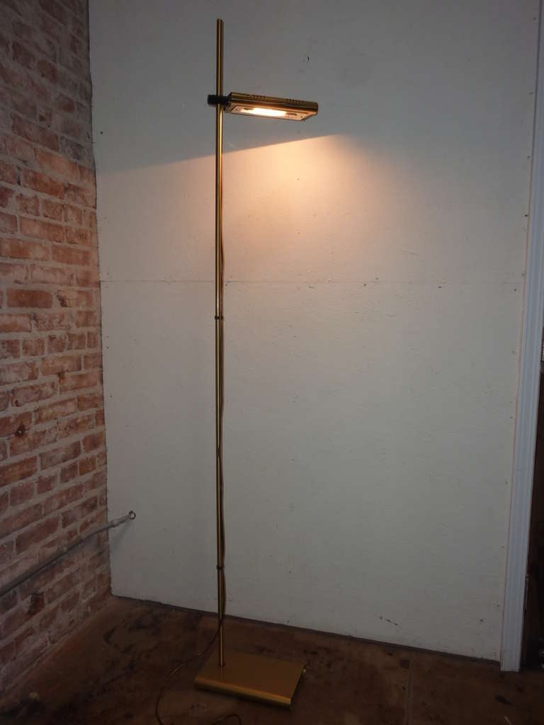 Brass base , adjustable height , pivoting lamp shade ,direct and indirect light .  Lighting with dimmer 200W Max.