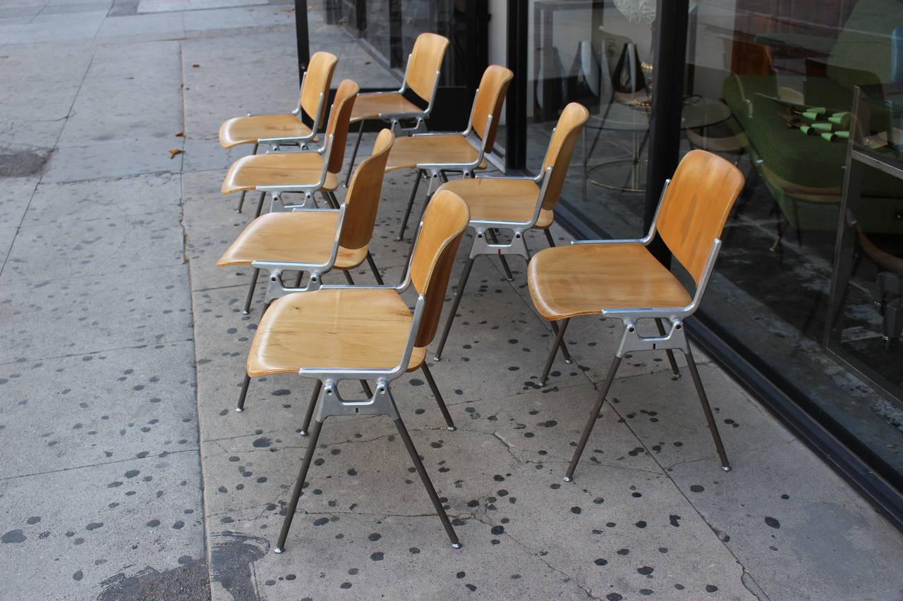 12 stackable chairs was designed by Giancarlo Piretti for Castelli. The frame is made from polished aluminium, the legs are coated in plastic. The seating surface and backrest are made from bent plywood. The chair is in a good vintage condition.