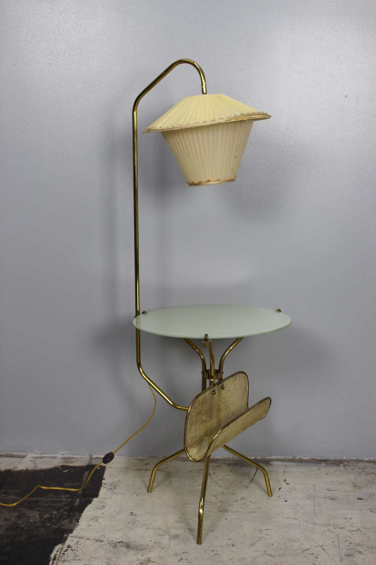 Lamp is in original vintage condition rewired and gray glass tabletop on brass base.
   
 table height 20   Diameter 15.5 
Magazine rack width 12 and  height 7 