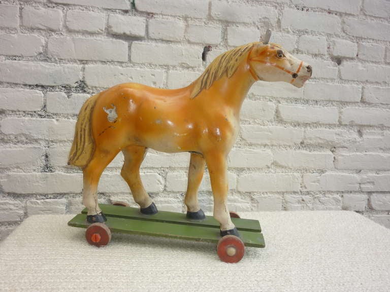 French antique horse toy on wheels with wood base.