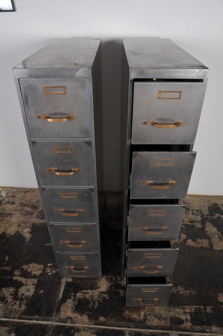 Two file cabinets striped to the bare metal ,on the smaller  scale .Sign on the bottom .