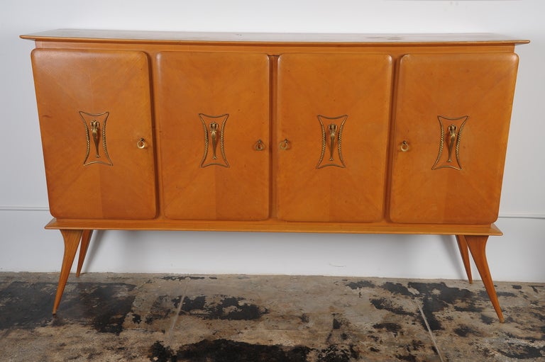 Italian  mid century large credenza-sideboard. Fruit wood with the brass hardware.