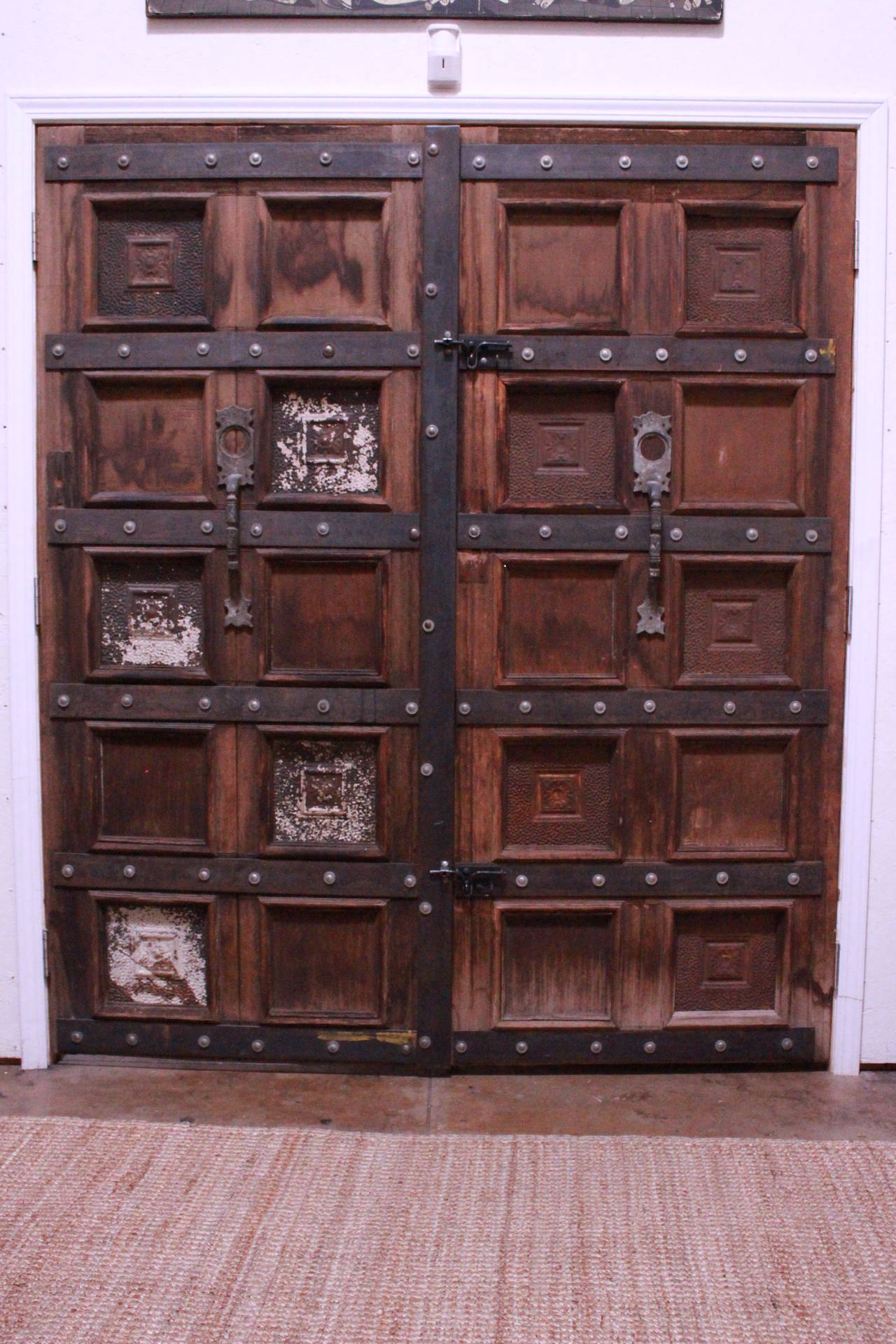 Double wooden door. Doors been reinforced with the metal bars at 1992 by Mateo Ferrer local artist  as shown on the photos. Came from Gypsy Antiques in Hollywood.
