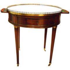 A Louis XVI Mahogany
Marble Bouillotte Table A Louis XVI Mahogany
Marble Bouillotte Table