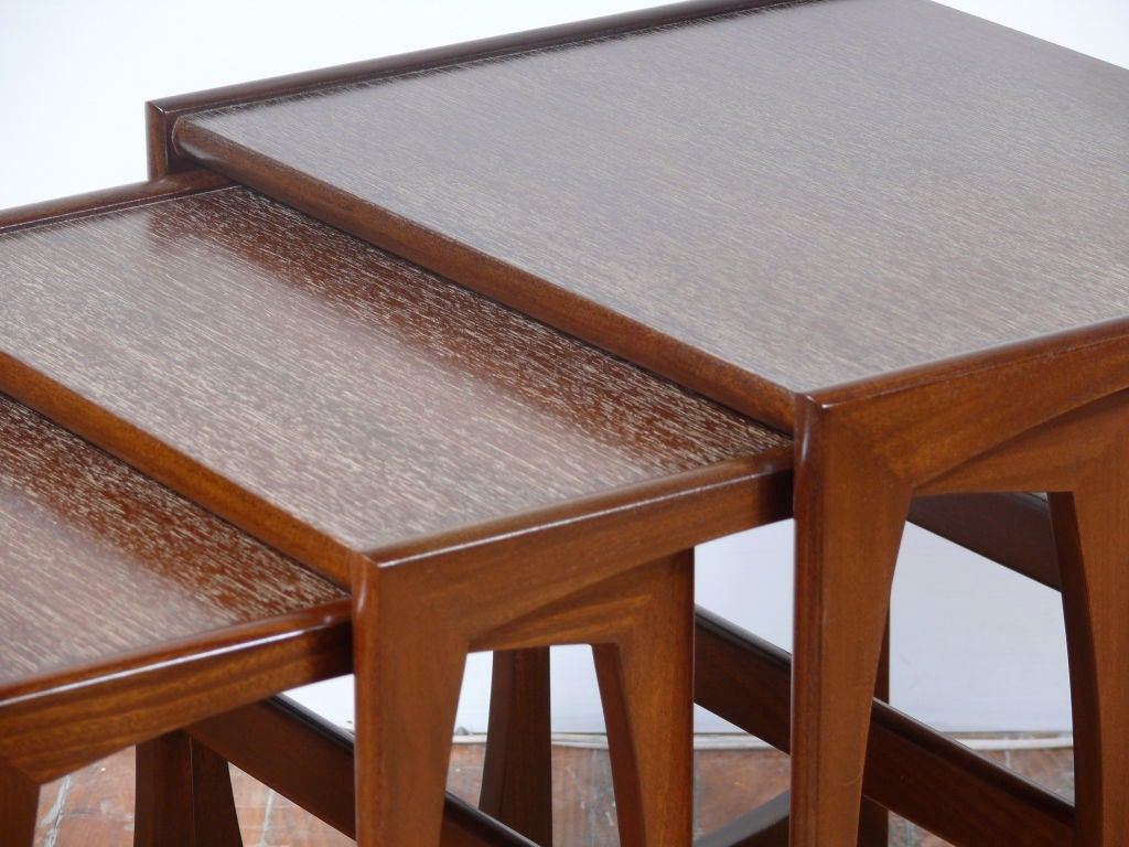 Set of three nesting tables in teak with a new brown cerused finish on them.  Tables stack under each other for easy storage and are flexible for multiple uses.