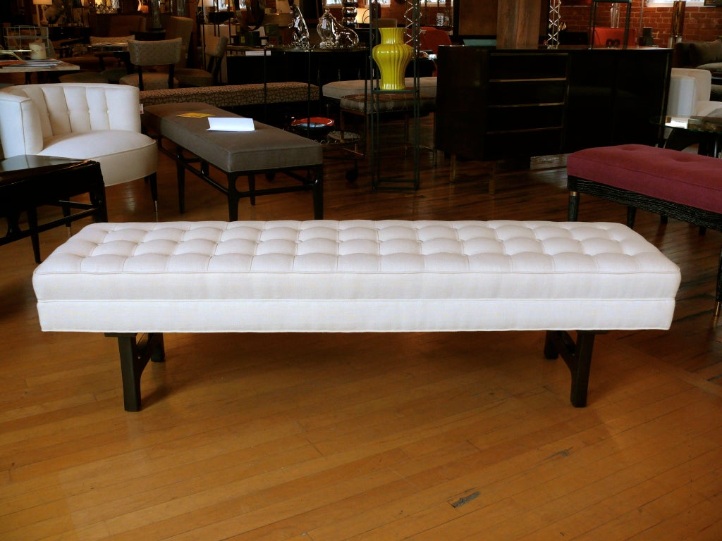Long white linen weave bench with seamed and buttoned top that sits on 2 danish modern inspired legs newly refinished in a deep chocolate.