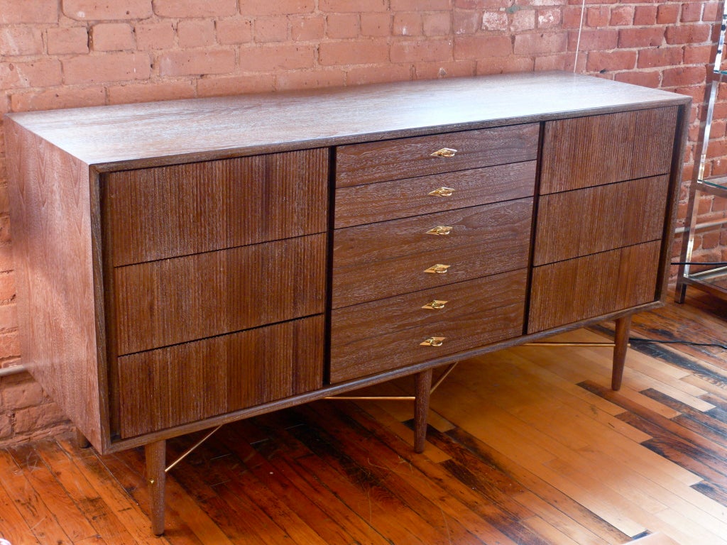 Elegant 9 drawer dresser credenza by American of Martinsville.  Incredible details throughout this piece from the combed wood side drawers to the exceptionally newly polished and plated brass drawer pulls to the solid brass diagonal leg stretchers.