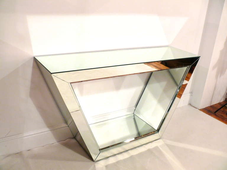 Mirrored console with art deco style setbacks.  Unusual trapezoid shape, fully mirrored on front, top and underneath top for a flawless reflection.  Back is not mirrored.  Excellent vintage condition