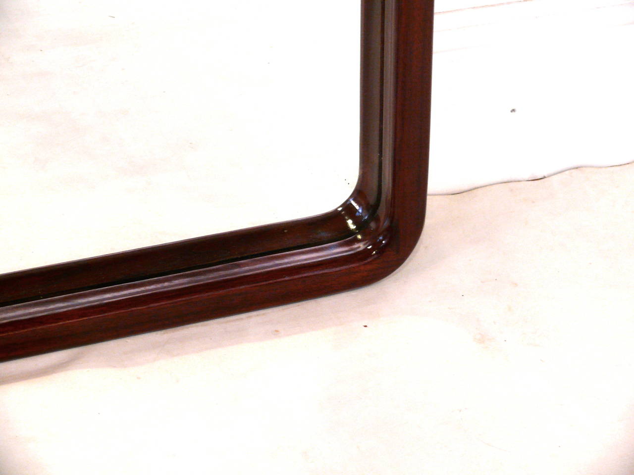 Large walnut mirror newly refinished, with a high gloss sheen. It could be hung both vertical and horizontal. It's in excellent condition.