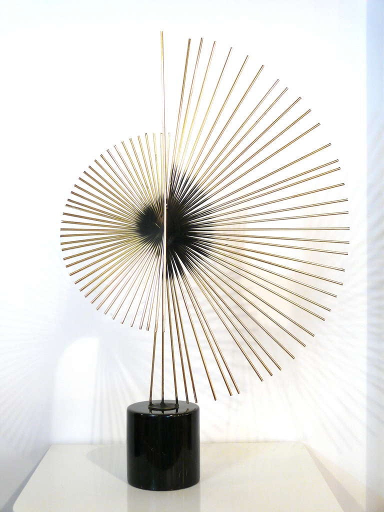 Brass fan spray sculpture by Curtis Jere @ 1984.  Iconic design with brass rods with black undertones on a black marble base.  Excellent vintage condition.
