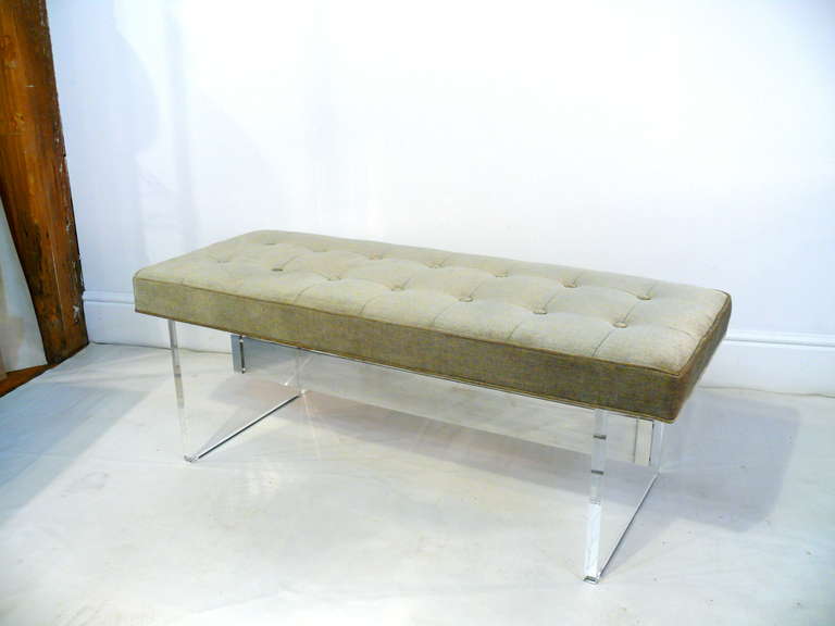 Exquisite 1960's trestle base lucite bench.  Lucite is newly polished with a single stretcher capped in chrome.  Top is newly upholstered with button tufted detail.