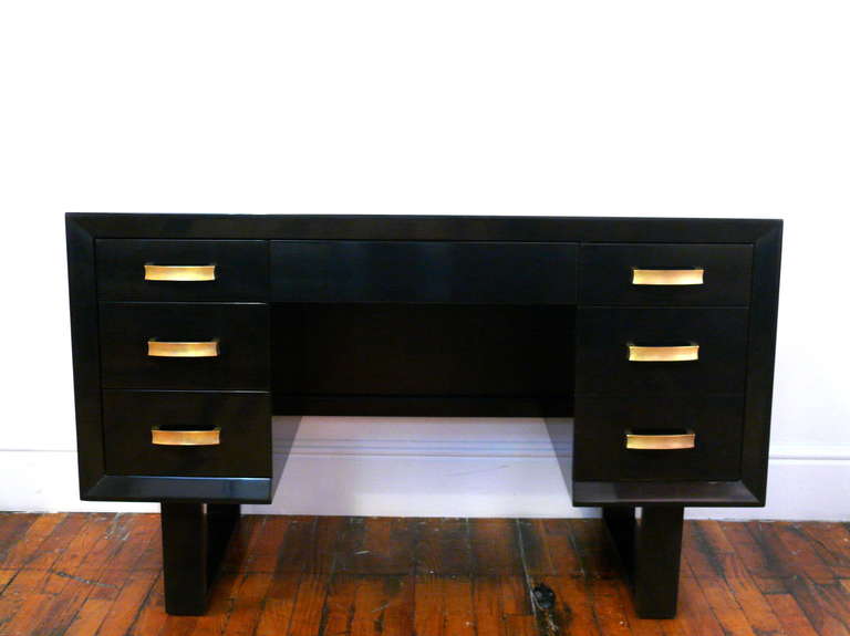 Seven drawer desk by TH Robsjohn Gibbings.  Newly refinished in a deep espresso with newly polished original hardware on drawers.