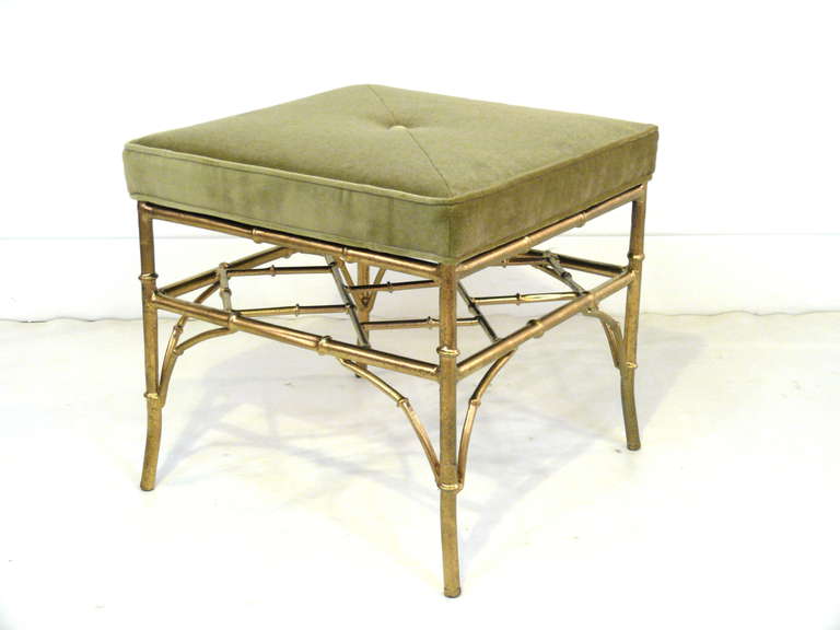 Pair of square faux bamboo ottomans with upholstered cushion top.  Frames are gilded and upholstery is green velvet.