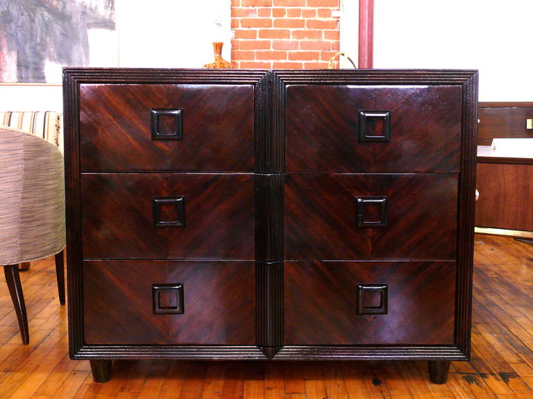 1940s Moderne six-drawer chest with bookmatched mahogany grain. Ribbed border. Wooden hardware.