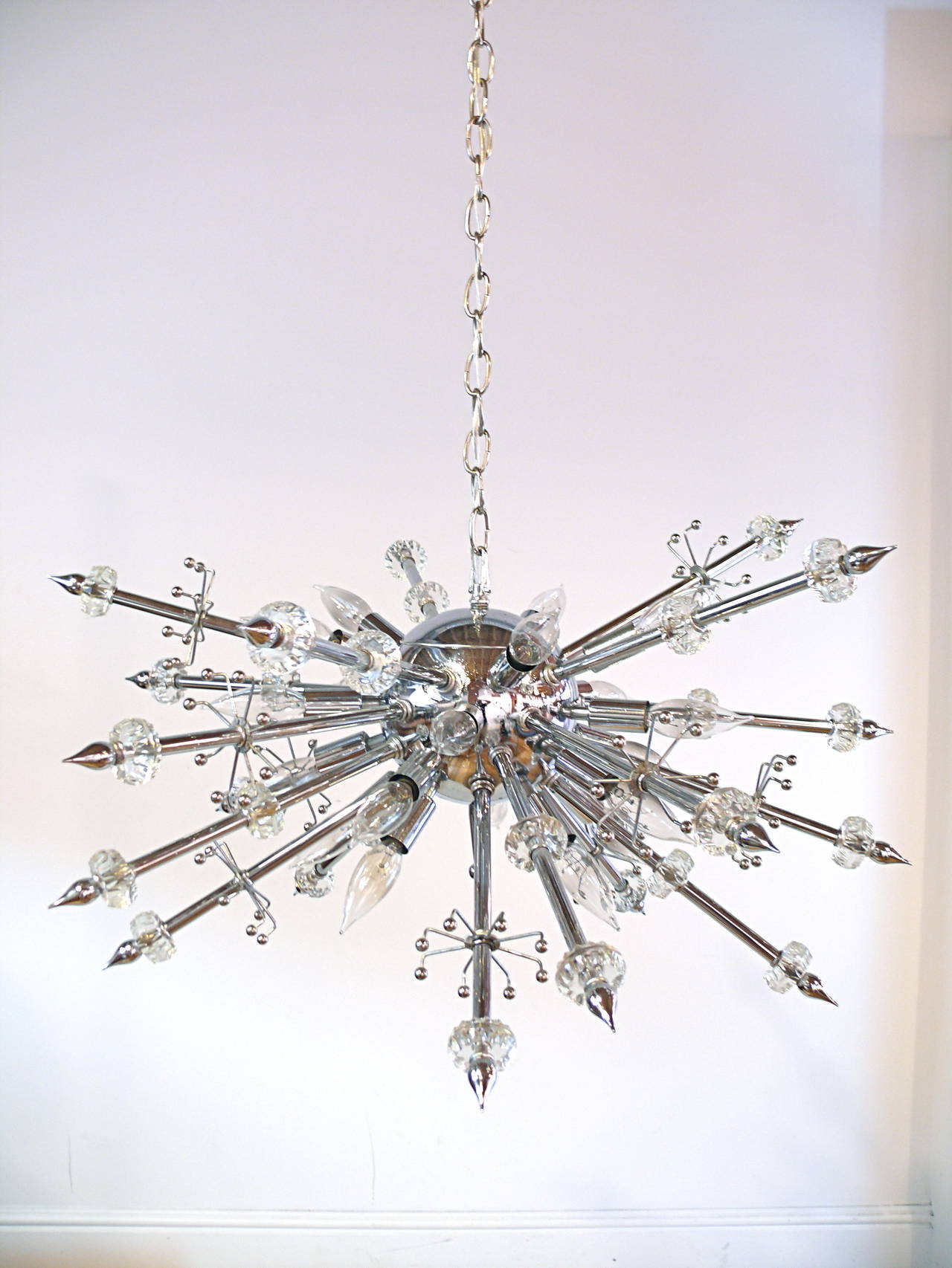 Incredible 1960s chrome and Lucite chandelier with 20 arms and 20 lights. Each arm has a Lucite faceted bead and a chrome finial.
Polished and rewired.