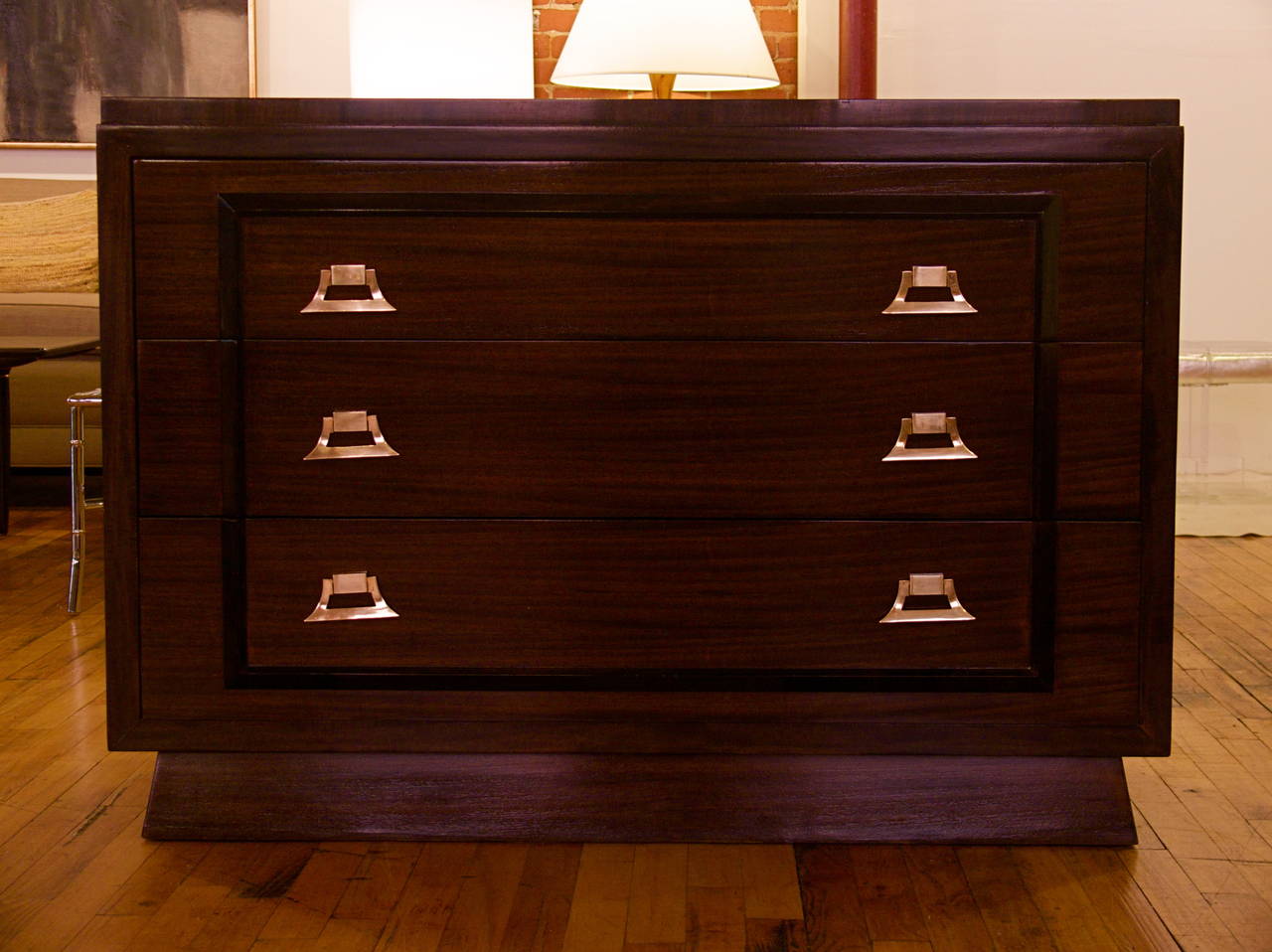 Great Mid-Century Modern three-drawer dresser finished in a dark chocolate, high gloss. Featuring bold, broad-beveled framing and exceptional grain. Each drawer is with plenty of room for storage, and each installed with a pair of stylish solid