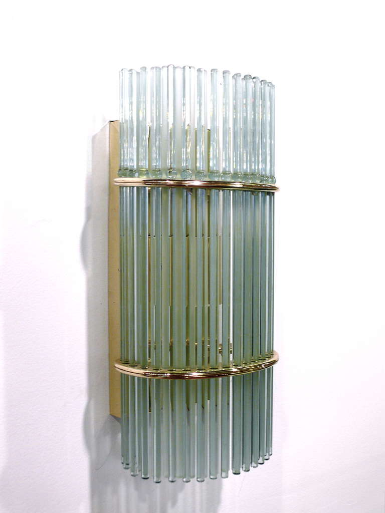 Pair of glass rod wall sconces by Gaetano Scolari.  The brass frame holds an outer layer of clear rods and an inner layer of frosted rods.  All glass rods are in perfect condition and the sconces rewired.