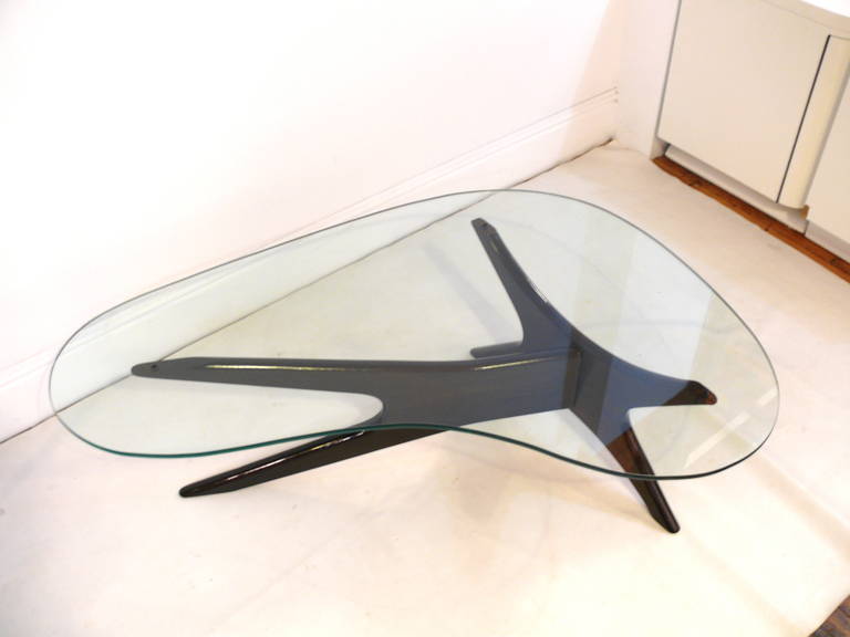 Elegant biomorphic coffee or cocktail table by Adrian Pearsall, circa 1960s. The two-piece base refinished in a high gloss dark walnut supports a new freeform glass top.