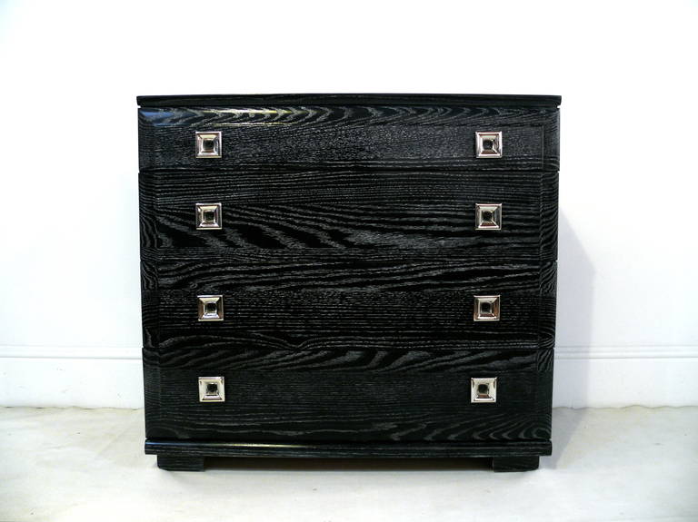 A four-drawer oak chests by Raymond Loewy for Mengel. The chests each rest on a slimly turned key base. Newly refinished in a silver ceruse with freshly polished square nickel pulls.