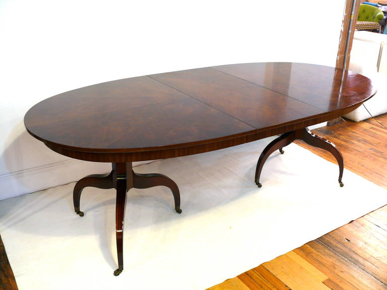 One of a kind tripod pedestal dining table finished in a rich high gloss mahogany with brass casters and a gorgeous starburst top grain design.  The table includes 2 leaves.

Width1: 72.25