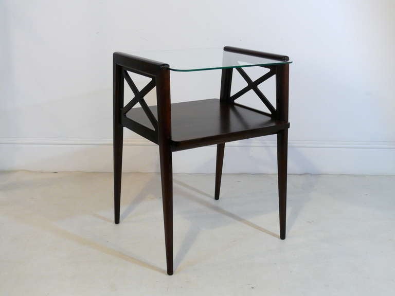 Stunning pair of tiered end tables finished in espresso. Tables have angled legs a glass top and x architectural details.