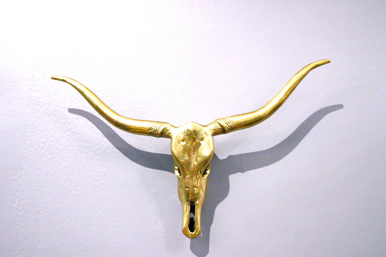 Gleaming brass longhorn skull sculpture beautifully detailed and ready to be wall-mounted or laid on a flat surface.
