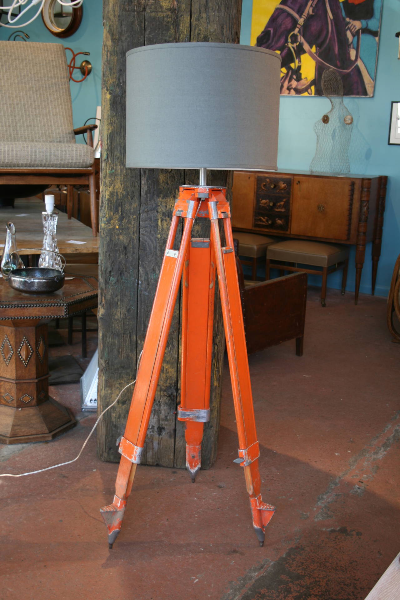 Identical pair of early 20th century wood and aluminum adjustable surveyor tripod bases by the Chicago Steel Tape Co., original orange paint, now as floor lamps, with new gray linen custom-made shades. Minimum height 55