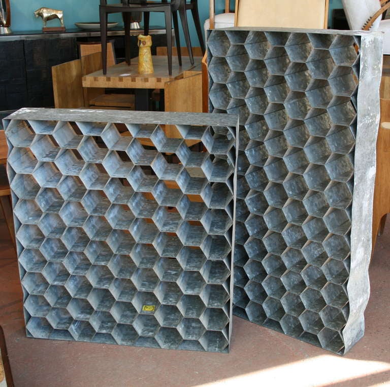Substantial galvanized metal wine storage racks, hexagonal honeycomb design, one is 77 bottles, the other is 81 bottles, retaining original 1950's maker label. Can go vertically or horizontally.