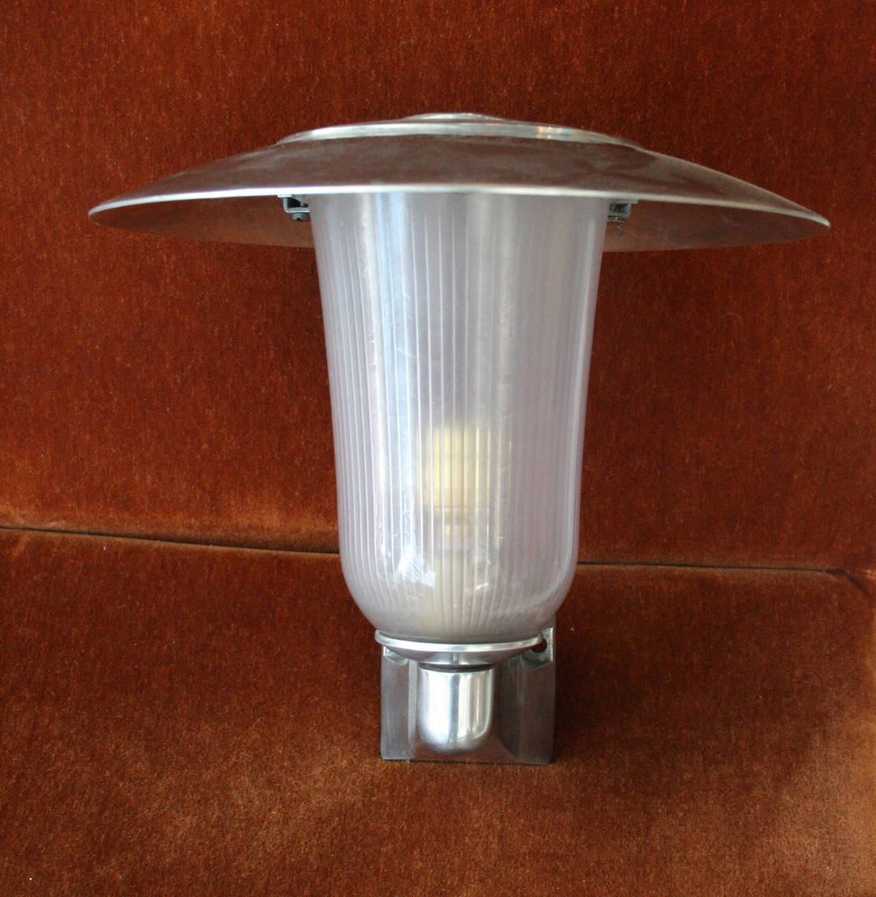 Set of 4 impressive French 1960's wall lights, comprised of cast aluminnum fittings, spun top hood, and holophane glass.