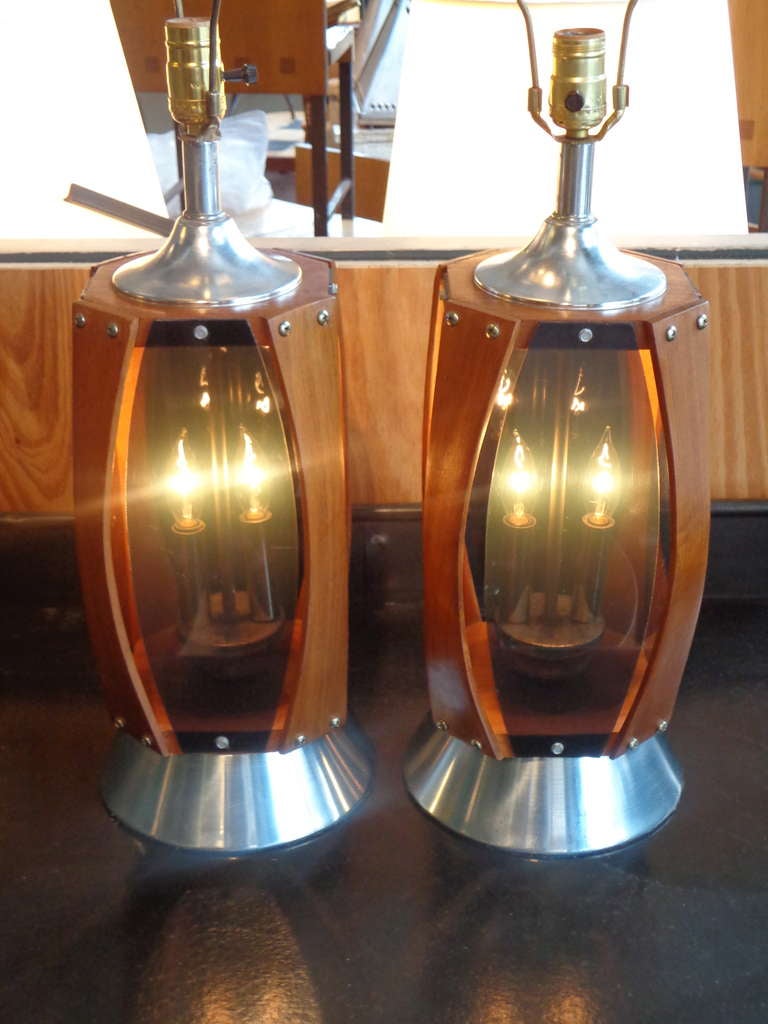 Pair of unusual Danish modern lamps with bent teak and black lucite panels, two lights encased in lower section. Chrome aluminium fittings, all new UL wiring