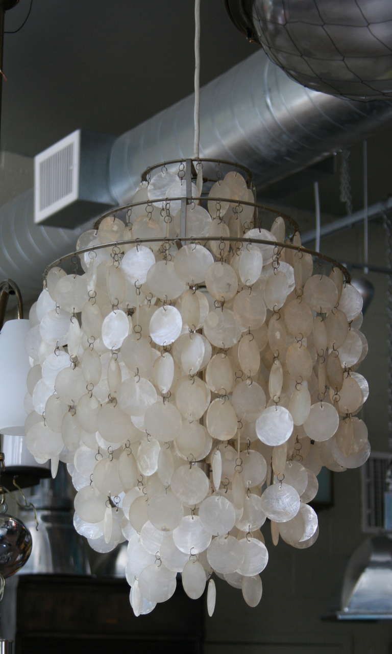 Beautiful and original translucent thin ivory shell disk chandelier designed by Verner Panton for Luber Switzerland. illuminated by two interior bulbs.