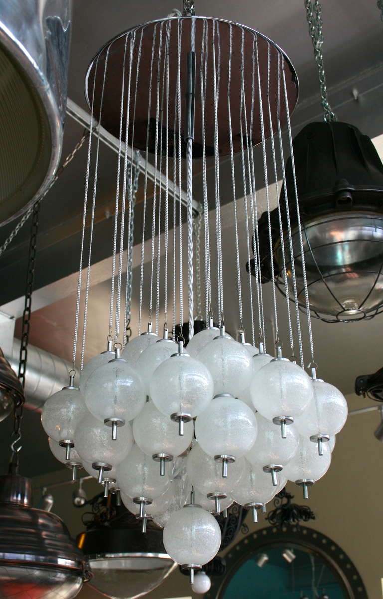 Ceiling mounted chandelier comprised of blown glass spheres, chrome fittings; interior five-light cluster.