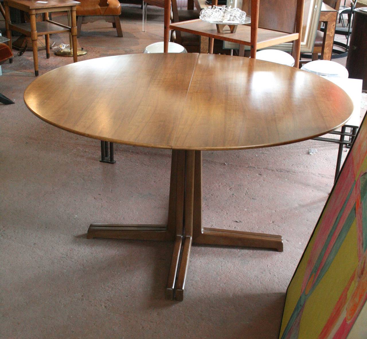 Lovely early Edward Wormley walnut extension dining table with its two leaves and original tag. Gorgeous age and color.