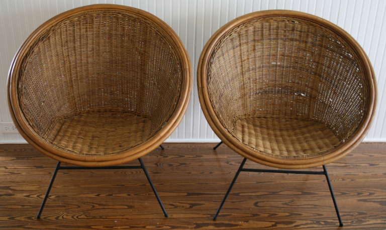 Pair of mid century modern woven wicker chairs, circle form.