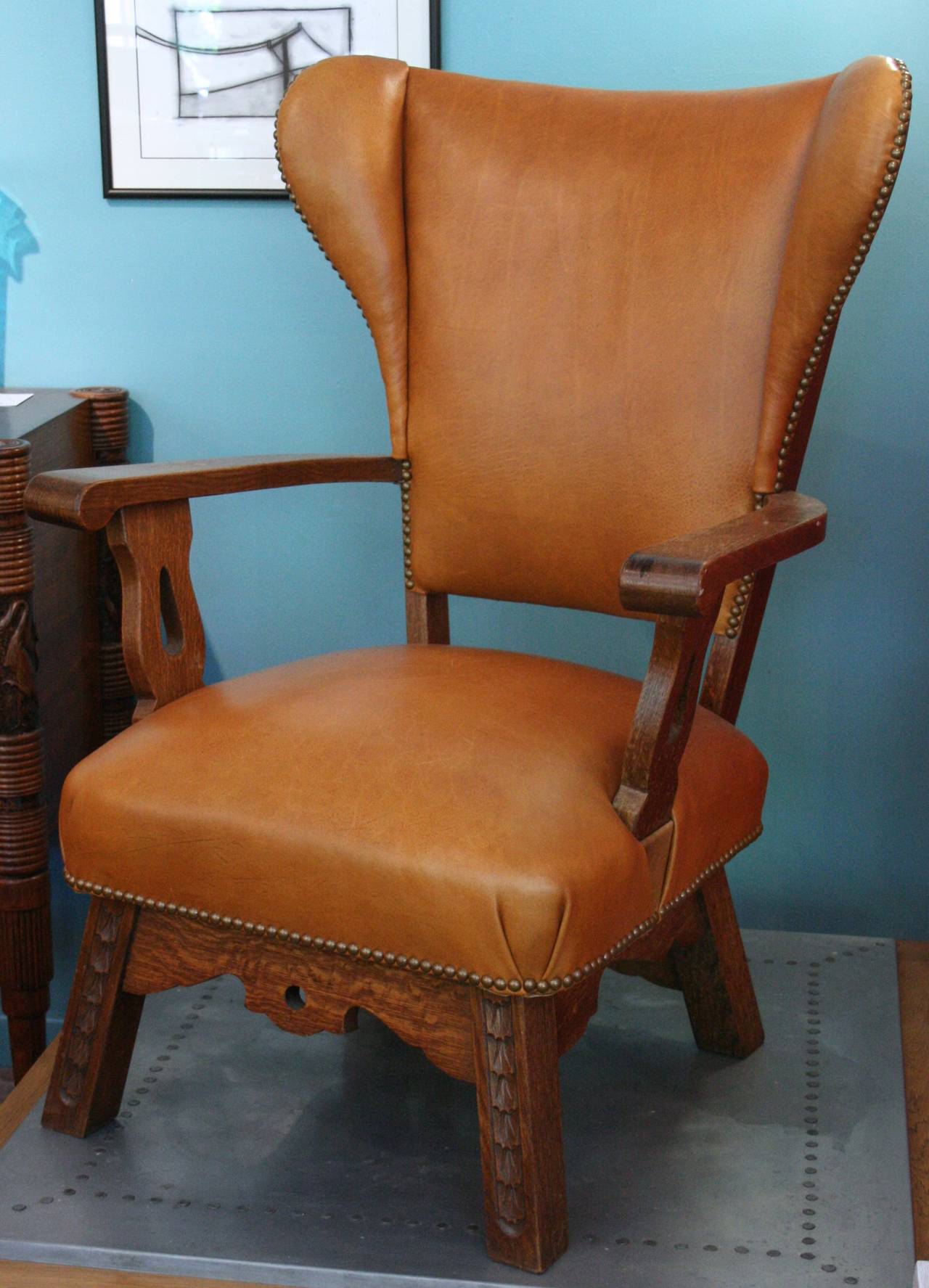 Unusual wing chair with carved detail on front, and drama on the back. Lovely  original condition.
Avantgarden Ltd. cultivates unexpected and exceptional lighting, furniture and design.  To view items in person please visit our showroom in Pound