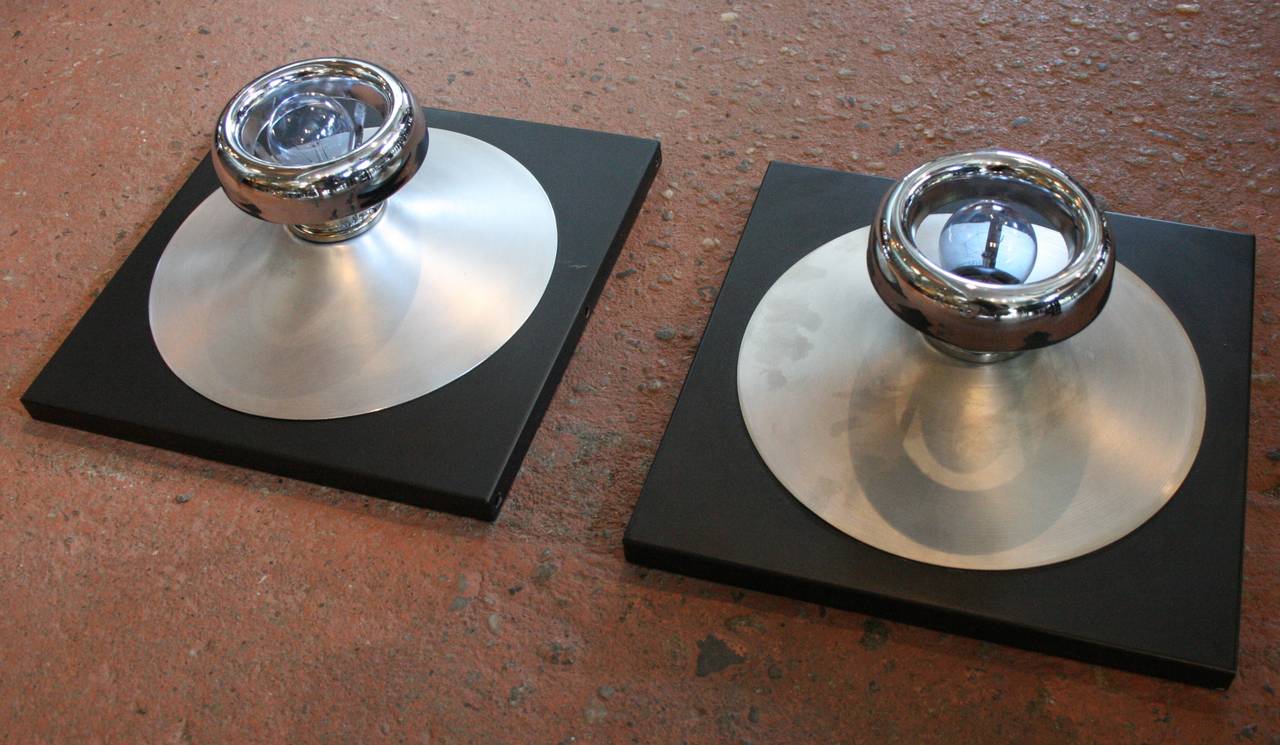 Pair of aluminum and chrome wall lights, in the style of Verner Panton, each with a single Edison socket which can accommodate any bulb.