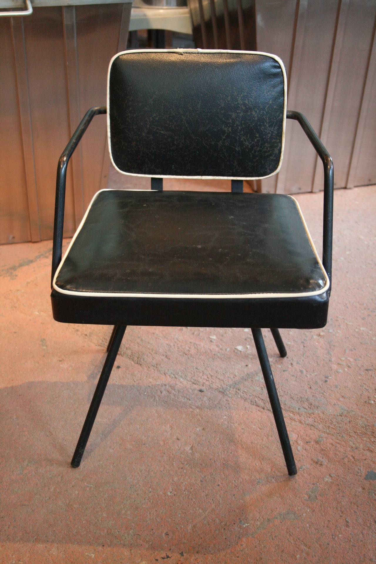 Vintage 1950s child's iron swivel chair in original back vinyl with white welting. 